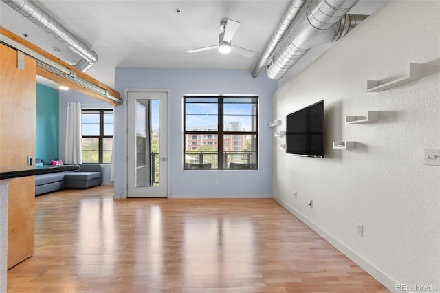7700 E 29th Ave Unit 304, Denver, CO 80238 - unfurnished living room with ceiling fan and wood finished floors