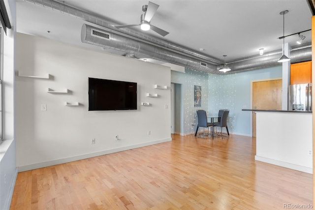 7700 E 29th Ave Unit 304, Denver, CO 80238 - living area with light wood finished floors and ceiling fan
