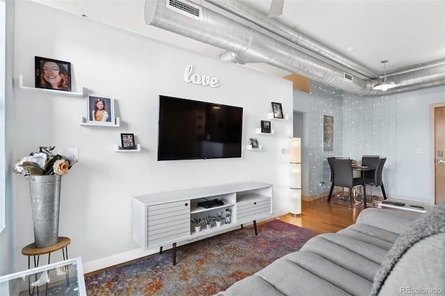 7700 E 29th Ave Unit 304, Denver, CO 80238 - living area featuring baseboards and wood finished floors