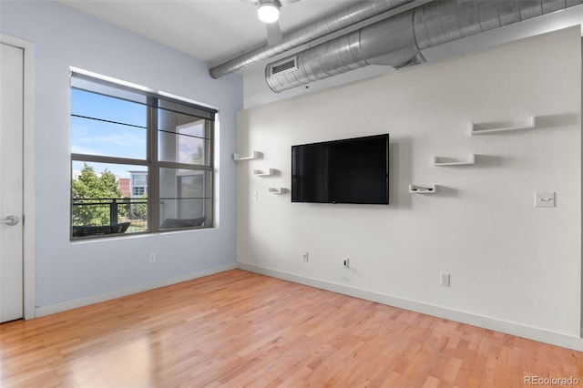 7700 E 29th Ave Unit 304, Denver, CO 80238 - unfurnished living room featuring wood finished floors