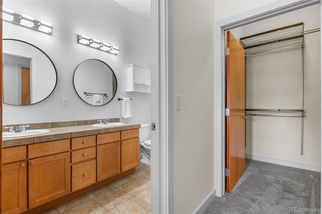 7700 E 29th Ave Unit 304, Denver, CO 80238 - bathroom with double vanity and toilet