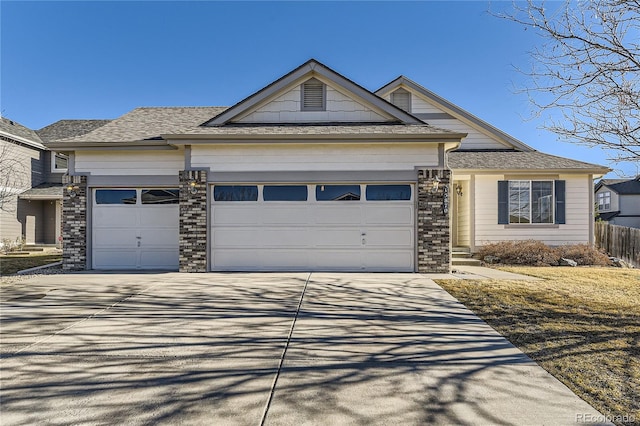 view of front of property featuring a garage, driveway, and fence