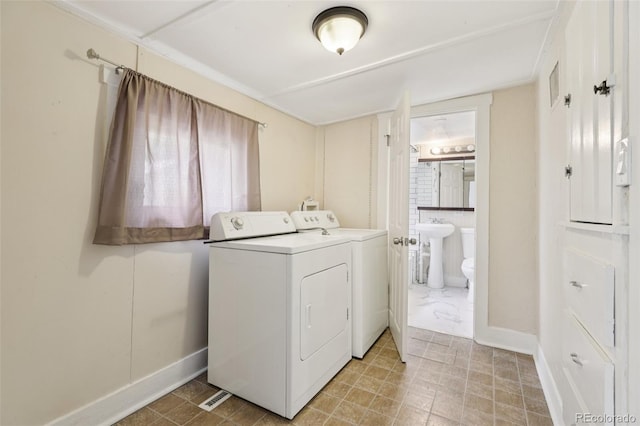 1340 Iola St, Aurora, CO 80010 - washroom featuring separate washer and dryer and baseboards