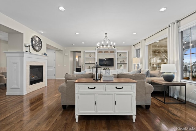 kitchen featuring a center island, white cabinetry, dark wood-type flooring, and a chandelier