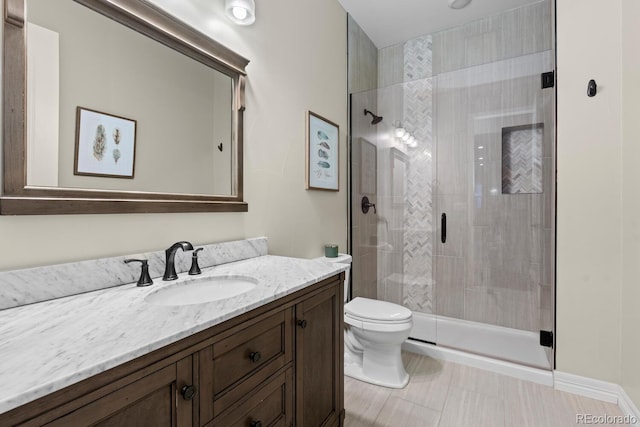 bathroom with vanity, an enclosed shower, and toilet