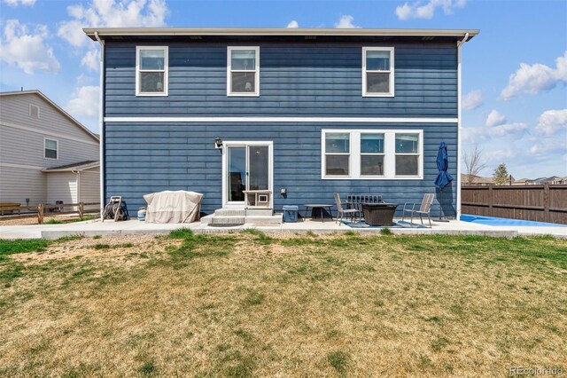 7498 E 157th Pl, Thornton, CO 80602 - back of house featuring a patio area, entry steps, and a fenced backyard