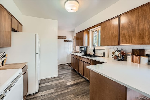 28669 Mountain View Rd, Conifer, CO 80433 - kitchen with a sink, light countertops, dark wood-style flooring, backsplash, and baseboards