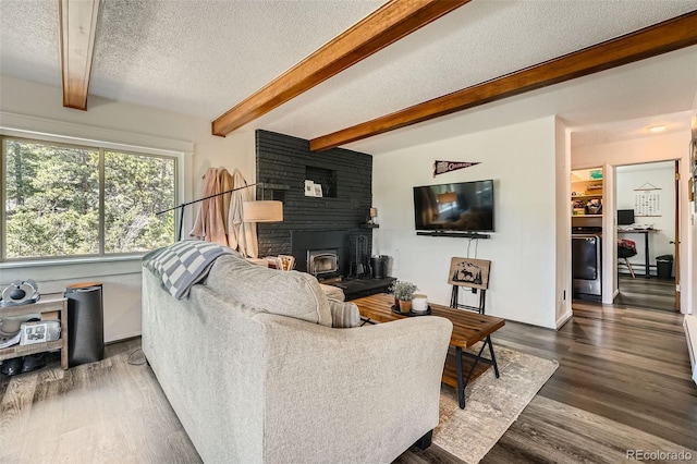 28669 Mountain View Rd, Conifer, CO 80433 - living room featuring a textured ceiling, beam ceiling, and dark wood finished floors