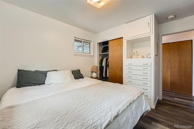28669 Mountain View Rd, Conifer, CO 80433 - bedroom featuring dark wood-style flooring, a textured ceiling, and a closet
