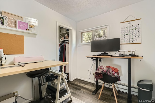 28669 Mountain View Rd, Conifer, CO 80433 - office space with wood finished floors, a textured ceiling, a baseboard radiator, and baseboards