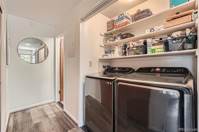 28669 Mountain View Rd, Conifer, CO 80433 - laundry area with separate washer and dryer, wood finished floors, and baseboards