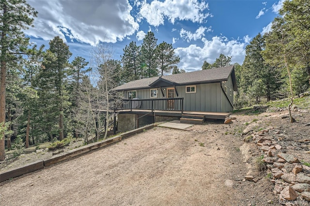 28669 Mountain View Rd, Conifer, CO 80433 - view of front of house with a wooden deck and board and batten siding
