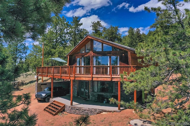 back of house featuring a patio and a wooden deck