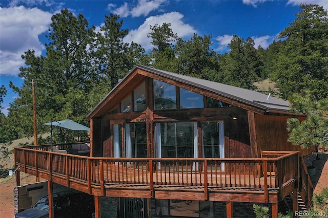 rear view of house featuring a deck