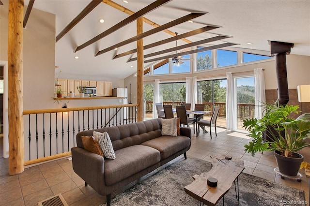 living room with light tile patterned floors, ceiling fan, beamed ceiling, and high vaulted ceiling