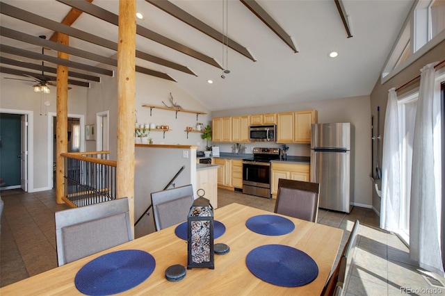 dining space with vaulted ceiling with beams, ceiling fan, and light tile patterned floors