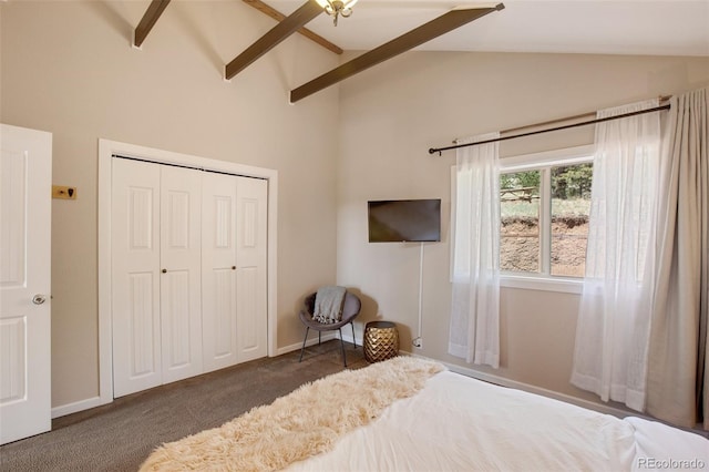 carpeted bedroom featuring vaulted ceiling with beams and a closet