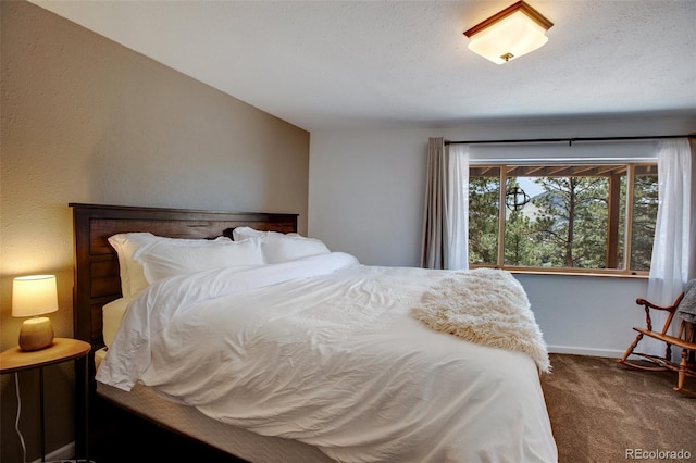 bedroom featuring a textured ceiling and carpet floors