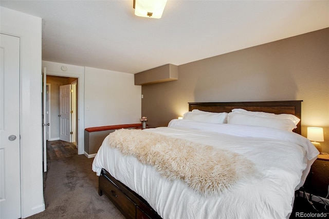 bedroom with dark colored carpet