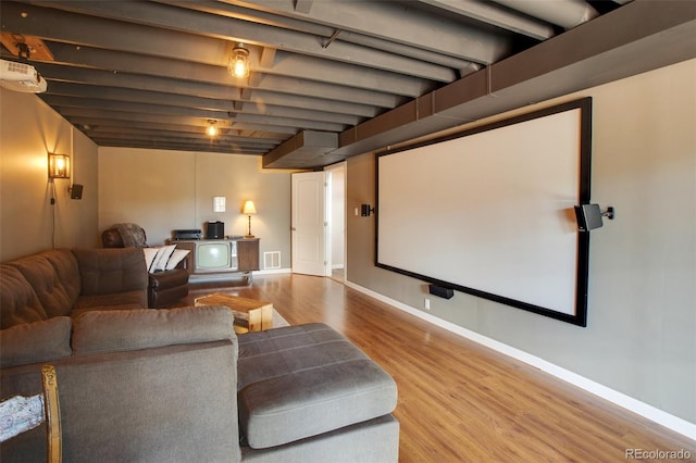 home theater room with wood-type flooring