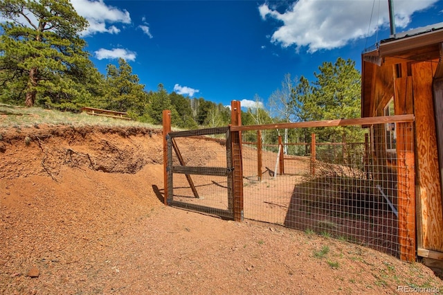 view of gate with an outbuilding