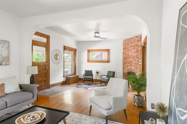 2845 Quitman St, Denver, CO 80212 - living room featuring arched walkways, wood finished floors, ceiling fan, and baseboards