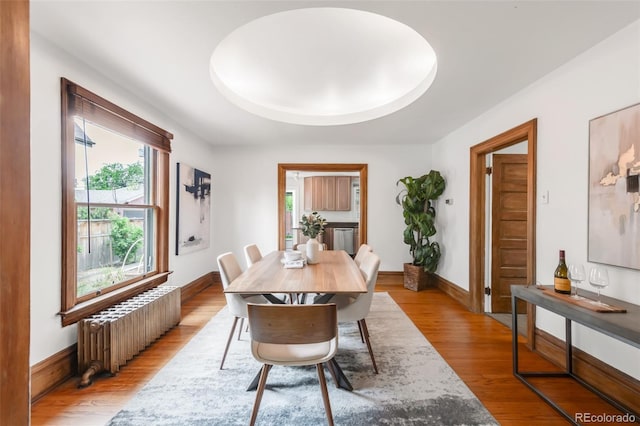 2845 Quitman St, Denver, CO 80212 - dining room featuring radiator heating unit, wood finished floors, and baseboards