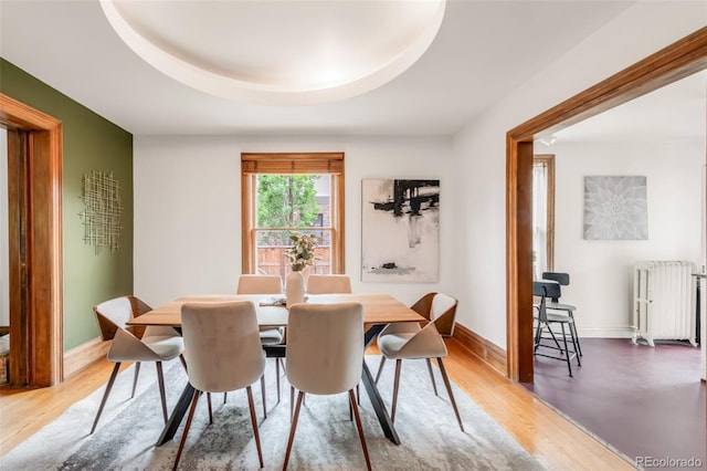 2845 Quitman St, Denver, CO 80212 - dining area featuring radiator heating unit, baseboards, and light wood-style flooring