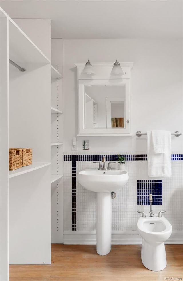 2845 Quitman St, Denver, CO 80212 - bathroom featuring a bidet, tile walls, wood finished floors, and a sink