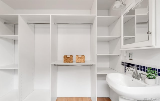 2845 Quitman St, Denver, CO 80212 - bathroom featuring tasteful backsplash, a sink, and wood finished floors
