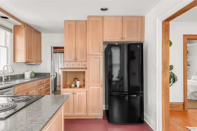 2845 Quitman St, Denver, CO 80212 - kitchen with freestanding refrigerator, a sink, cooktop, light brown cabinets, and stone countertops