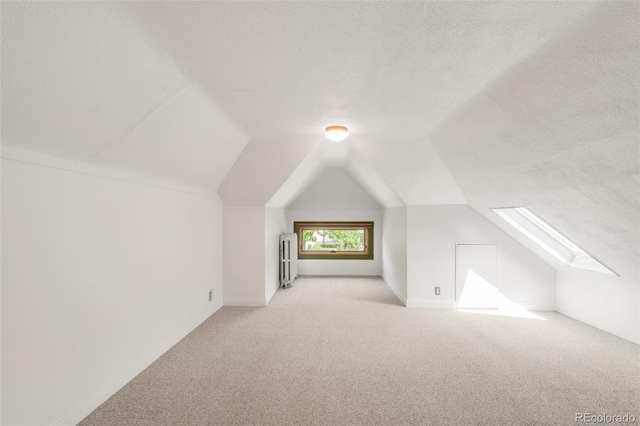 2845 Quitman St, Denver, CO 80212 - bonus room featuring carpet flooring, lofted ceiling, a skylight, a textured ceiling, and baseboards