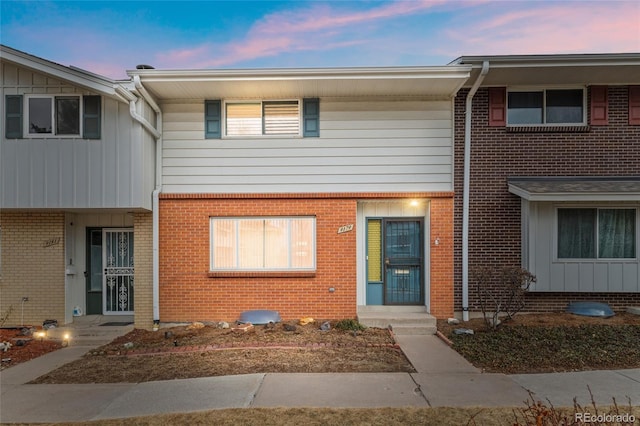 townhome / multi-family property with brick siding