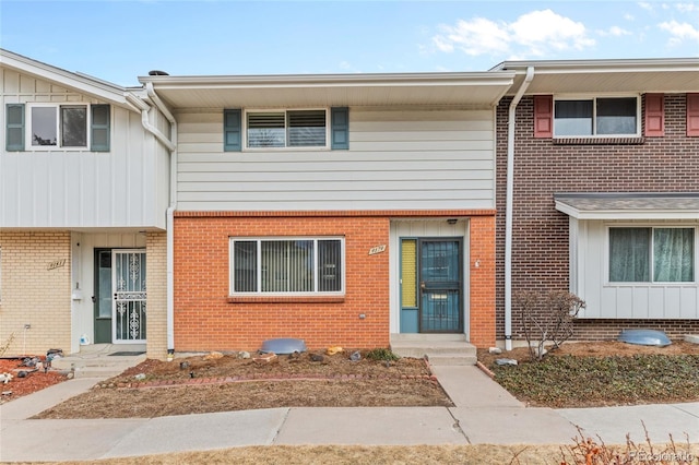 townhome / multi-family property with brick siding