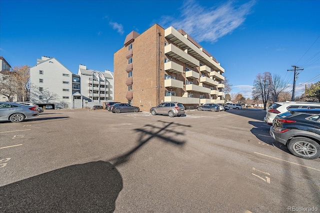 view of building exterior with uncovered parking