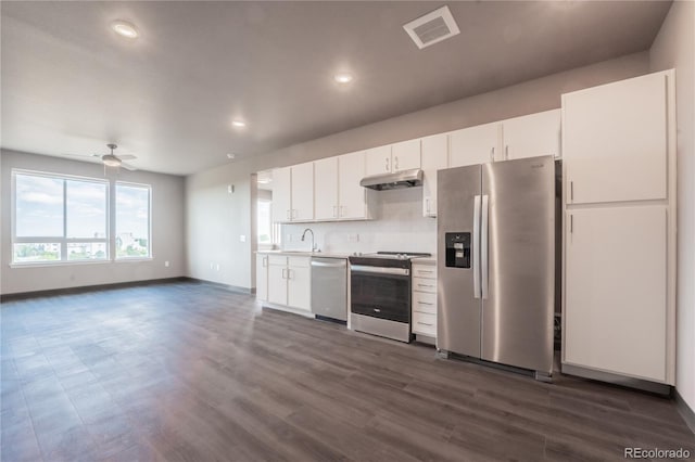 kitchen with sink, ceiling fan, backsplash, stainless steel appliances, and white cabinets