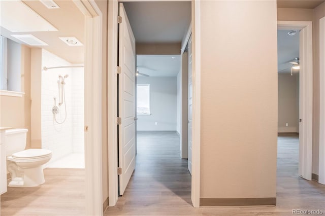 hallway with light hardwood / wood-style floors