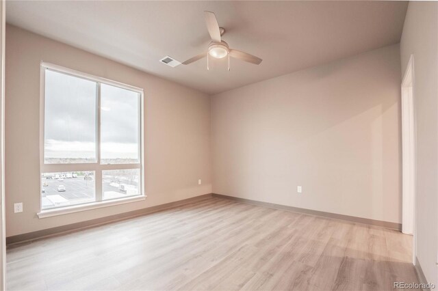 spare room featuring light hardwood / wood-style flooring and ceiling fan