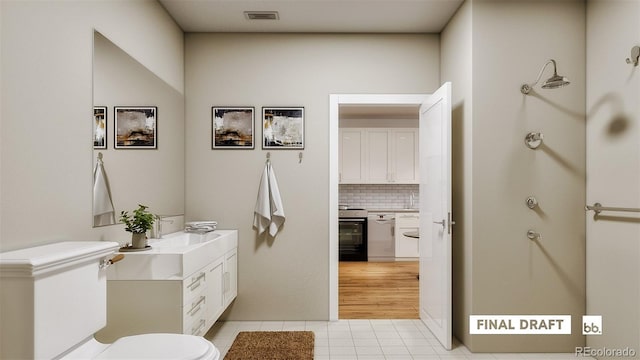 bathroom with vanity, tile patterned flooring, and backsplash