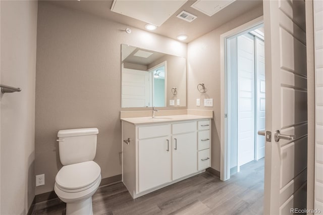 bathroom featuring vanity, hardwood / wood-style flooring, and toilet