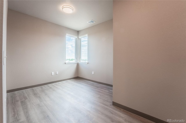 spare room with light wood-type flooring