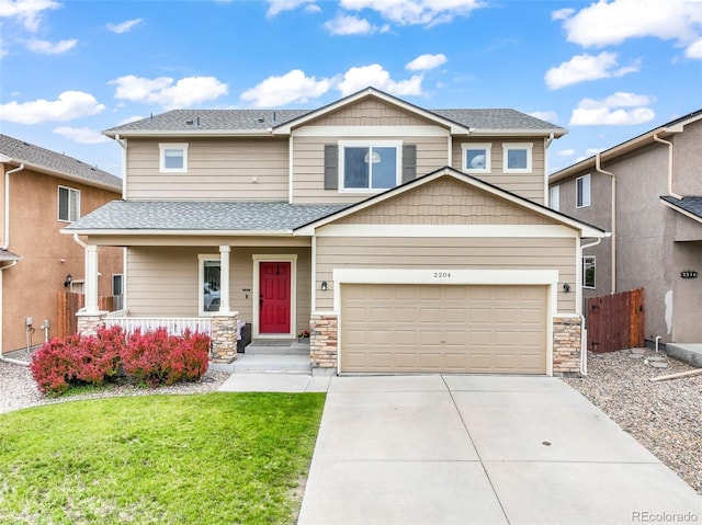 2204 Reed Grass Way, Colorado Springs, CO 80915 - view of front of home featuring a porch, concrete driveway, stone siding, a garage, and roof with shingles