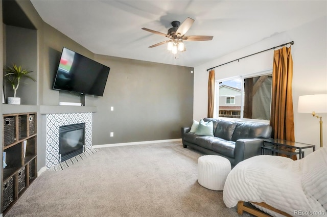 2204 Reed Grass Way, Colorado Springs, CO 80915 - carpeted living area with ceiling fan, a tiled fireplace, and baseboards