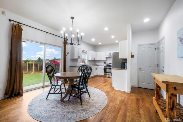 2204 Reed Grass Way, Colorado Springs, CO 80915 - dining space with a chandelier, light wood-style floors, and recessed lighting