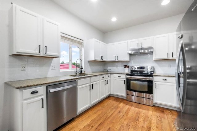 2204 Reed Grass Way, Colorado Springs, CO 80915 - kitchen featuring stainless steel appliances, a sink, under cabinet range hood, white cabinetry, and recessed lighting
