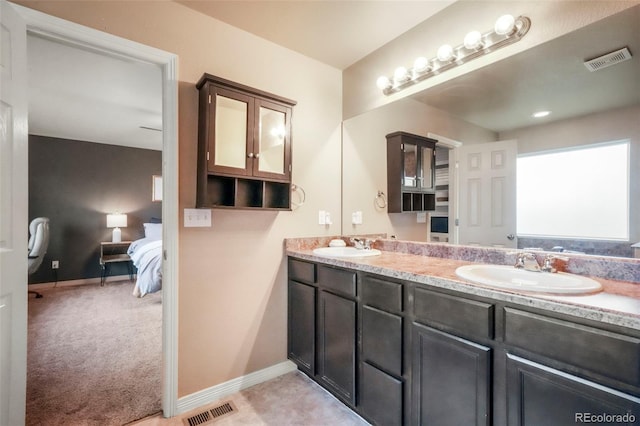 2204 Reed Grass Way, Colorado Springs, CO 80915 - ensuite bathroom featuring double vanity and baseboards
