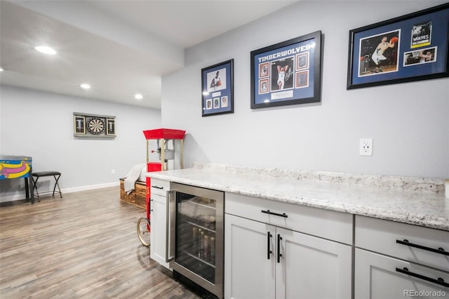 2204 Reed Grass Way, Colorado Springs, CO 80915 - indoor dry bar with beverage cooler, light wood-style floors, recessed lighting, and baseboards