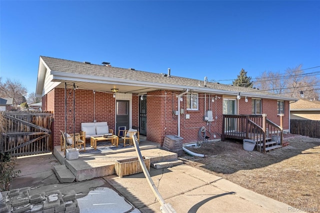 rear view of house featuring outdoor lounge area and a patio