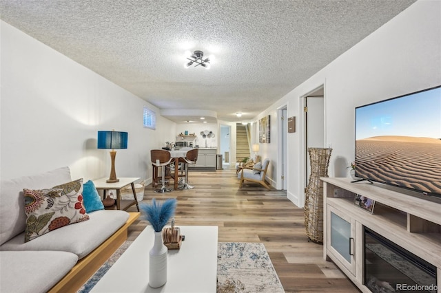 living room with hardwood / wood-style floors and a textured ceiling