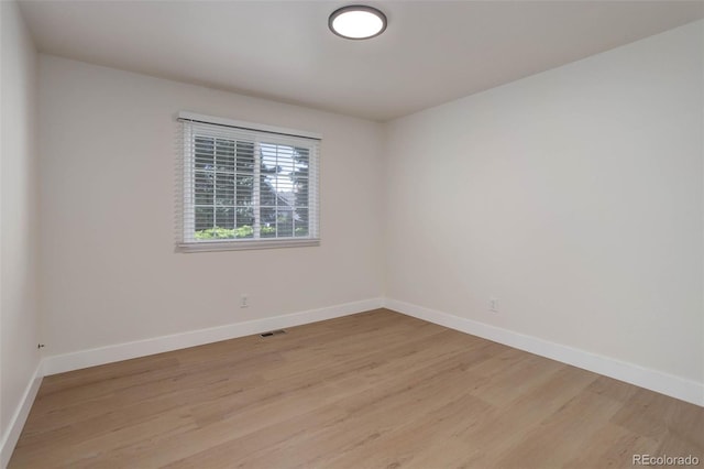 6055 W Warren, Lakewood, CO 80227 - spare room with baseboards and light wood-style flooring
